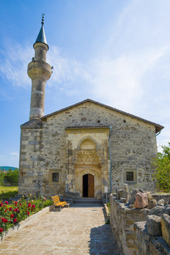 At the entrance to the medieval mosque of Khan Uzbek on a sunny June day. Old Crimea