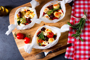 baked small dumplings with zucchini tomatoes and diced sheep's cheese