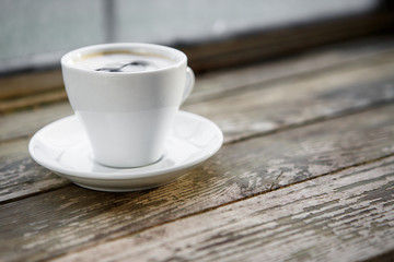 Cup of hot coffee on the wooden table