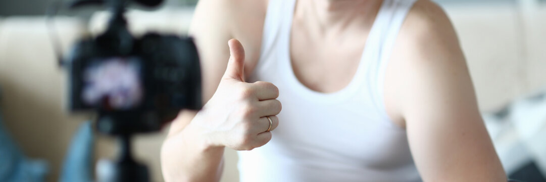 Happy Sportsman with Dumbbell Showing Thumb Up