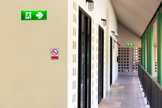 green emergency exit sign to install over the door building construction showing the way to escape