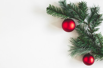 Christmas composition. Fir tree branches, red balls on white background. Christmas, winter, new year concept. Flat lay, top view, copy space