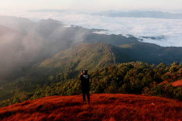 tourist at the top of the mountain During sunset