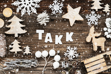 White Letters Building The Word Takk Means Thank You. Wooden Christmas Decoration Like Seld And Tree And Star. Brown Wooden Background With Snowflakes