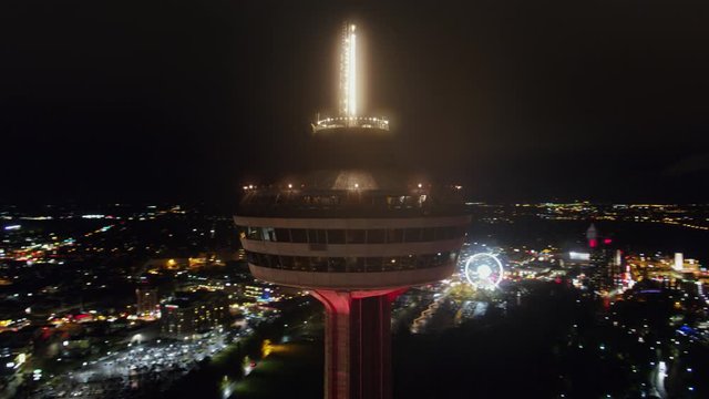 Niagara Falls Ontario Aerial v21 Full nighttime panoramic of Skylon Tower close up with cityscape and Falls in background - October 2017