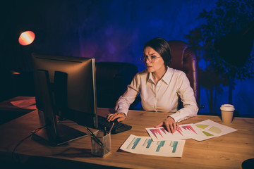 Fototapeta na wymiar Portrait of nice attractive stylish lady top executive manager company agency owner preparing report strategy investment ratio result analyzing economy audit at night dark work place station
