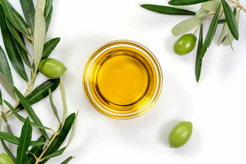 Olive oil. Greek olive oil in glass transparent bowl with branches with leaves and olives, with...