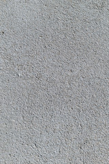 Gray textured cement wall background with fine concrete chips. Construction backgrounds