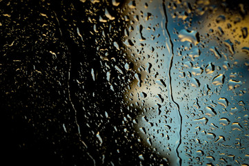 water drops on a glass car in rain