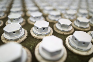 Pile of bolts in special box at industrial plant
