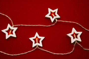 Illuminated star shaped garland on color background close up
