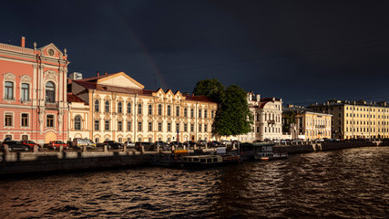 Russia, Saint Petersburg, near Neva river: Row of beautiful renovated apartment houses with boats on Fontanka river in late afternoon midnight sun in the city center of the Russian town.