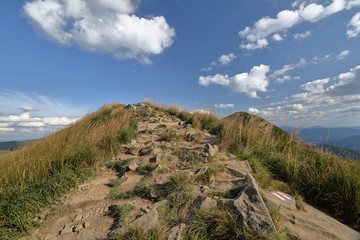 Landscape of Bieszczady mountains in Poland, blue sky with white clouds