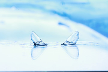 Tools for vision correction. Glasses and lenses with diopters on the background of splashes and...