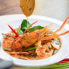 Hot and spicy traditional famous Thai food Tom Yum Kung soup