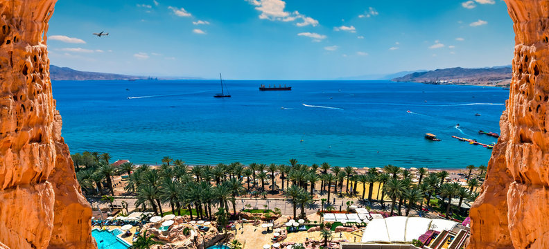 Central public beach of Eilat -  Israeli southernmost tourist and resort city, located on the northern shores of the Red Sea, concept of blissful and happy vacation