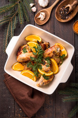 Christmas Dinner. Fried chicken wings with orange slices shot. Traditional festive food