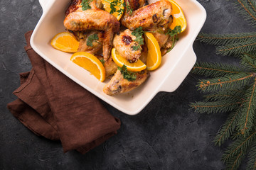 Christmas Dinner. Fried chicken wings with orange slices shot. Traditional festive food