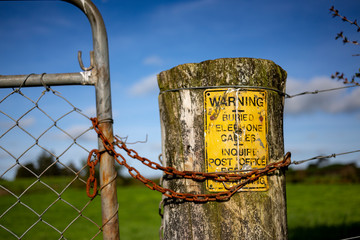 Chain and gate with yellow sign