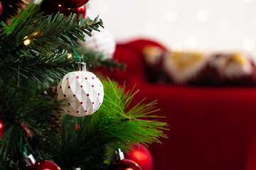 Obraz premium Red and white baubles hanging from a Christmas tree close up