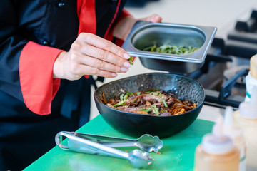 Chef stirring pasta