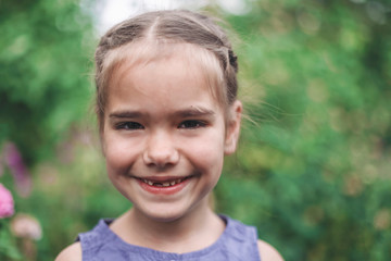 Adorable 6-7 years old girl with toothless smile