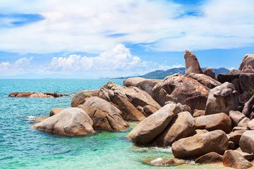 Hin Ta and Hin Yai rocks view close up, Grandmother and Grandfather stones on blue sea, sunny cloudy sky background, famous tourist natural landmark on Lamai beach, Koh Samui tropical island, Thailand
