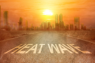 Heatwave text on the street on the city with the glowing sun background
