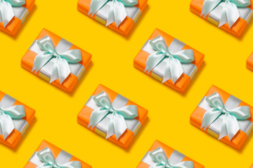 Pattern with stylish gift on a trendy orange background. Present for St. Valentine's day, engagements, Mother's Day, birthday, New Year, Christmas, holidays