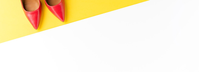 Fashion background with red high heels on abstract background with copyspace. Top view. Banner