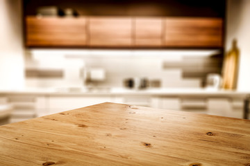 Kitchen table top with empty space for you products or decoration and blurred kitchen furniture...