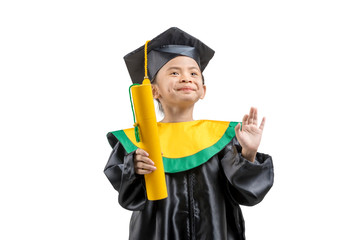 Asian little girl in hat and graduation gown holding certificate