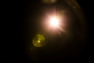 Abstract Natural Sun flare on the black background.