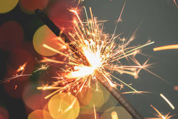 Close-up of holiday Christmas sparkler on dark background