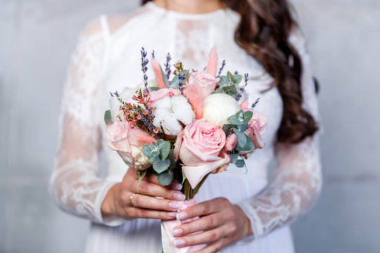 The bride holds a wedding bouquet. Close-up, flowers.