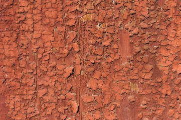 Old and peeling paint Over time, the red paint peeled off from the old boards and the wood texture cracked. Vintage Abstract Grunge Background