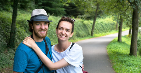 Сouple are walking in a beautiful forest on a hiking trip