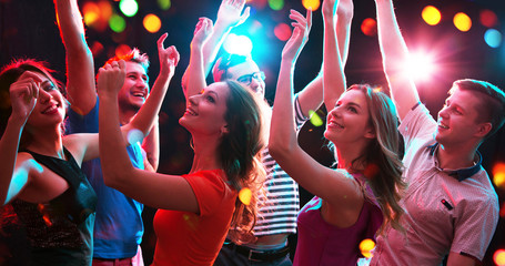 Group of young people having fun dancing at party.