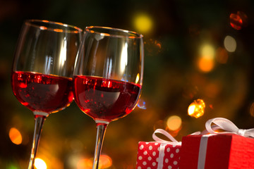 Glasses of wine and Christmas balls on the background of Christmas lights