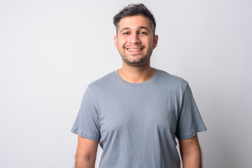 Obraz premium Portrait of happy young handsome Persian man smiling
