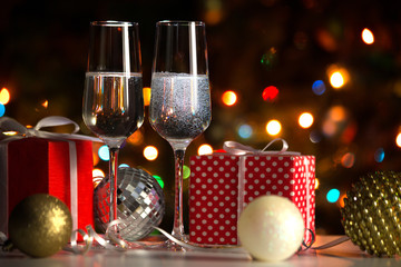 Champagne glasses and Christmas balls and Christmas gifts