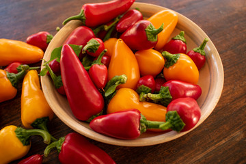 food background. soft focus of red and yellow chili peppers in ceramic bowl