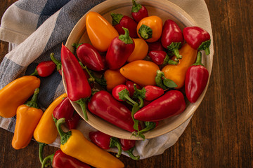 food background. soft focus of red and yellow chili peppers in ceramic bowl