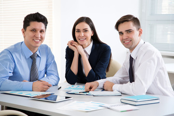 Young business people smiling looking at camera