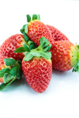 pile of strawberries on a white background