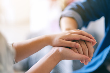 A man and a woman holding each other hands for comfort and sympathy