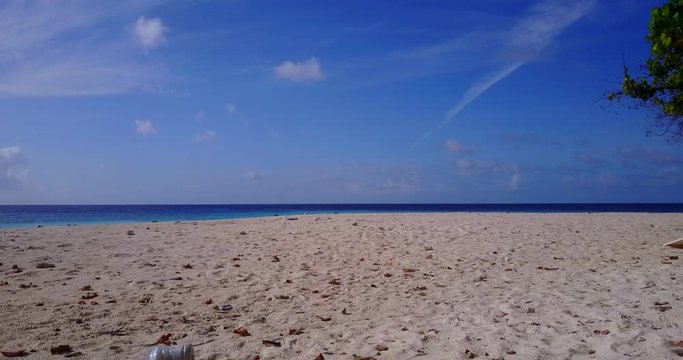 Drone flyes very close to the golden beach 