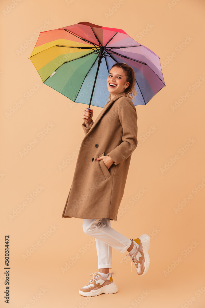 Sticker photo of laughing attractive woman holding umbrella while walking