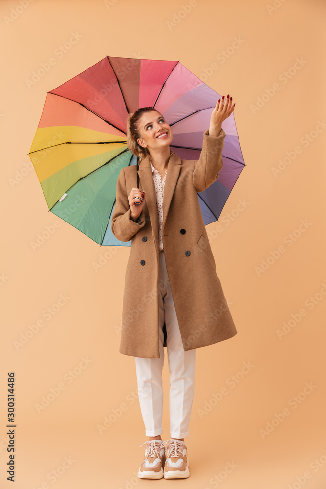 Canvas Prints Photo of smiling attractive woman holding umbrella while standing