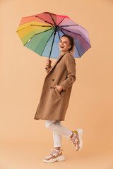 Photo of laughing attractive woman holding umbrella while walking